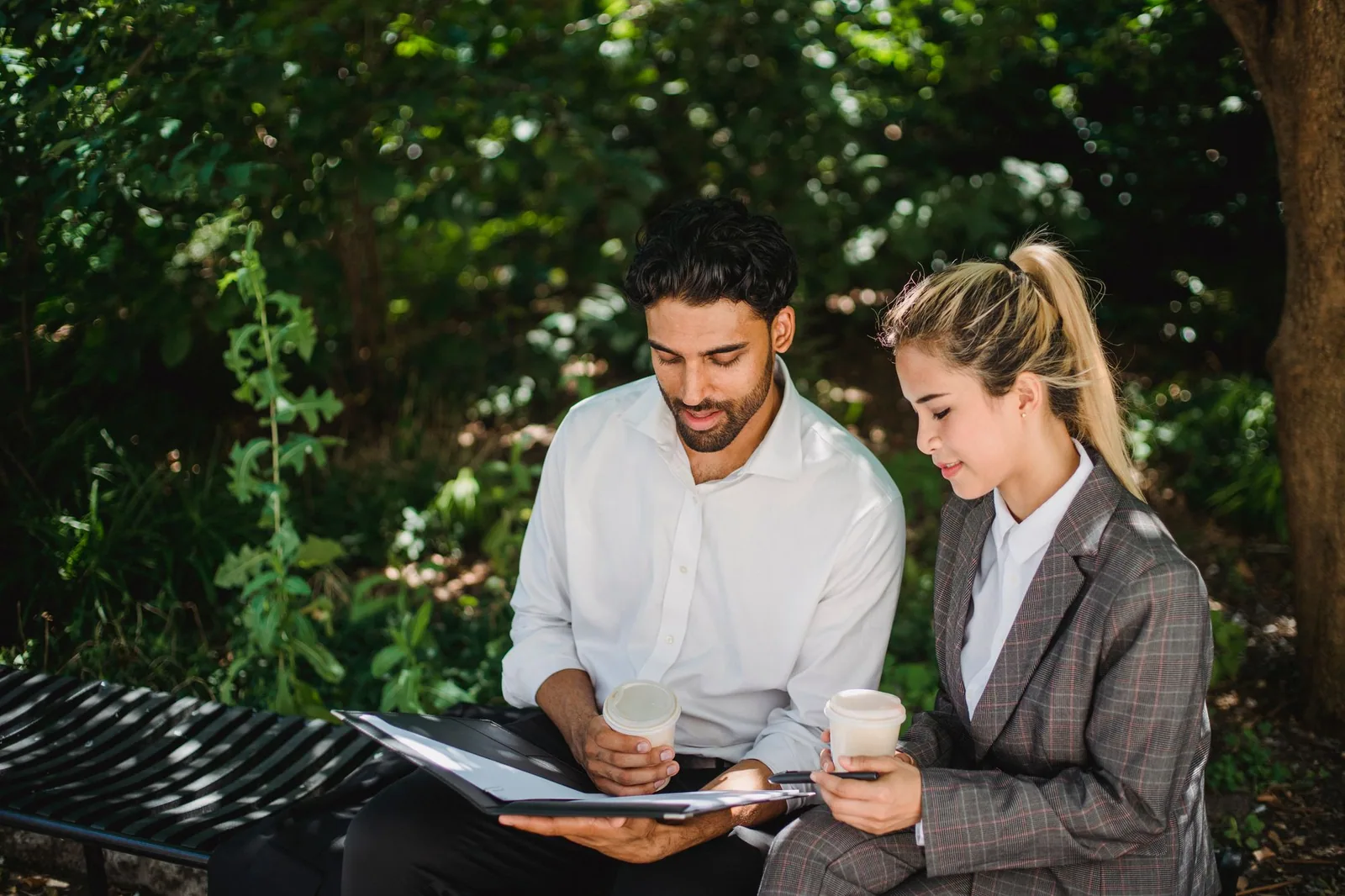 Two professionals discussing business documents