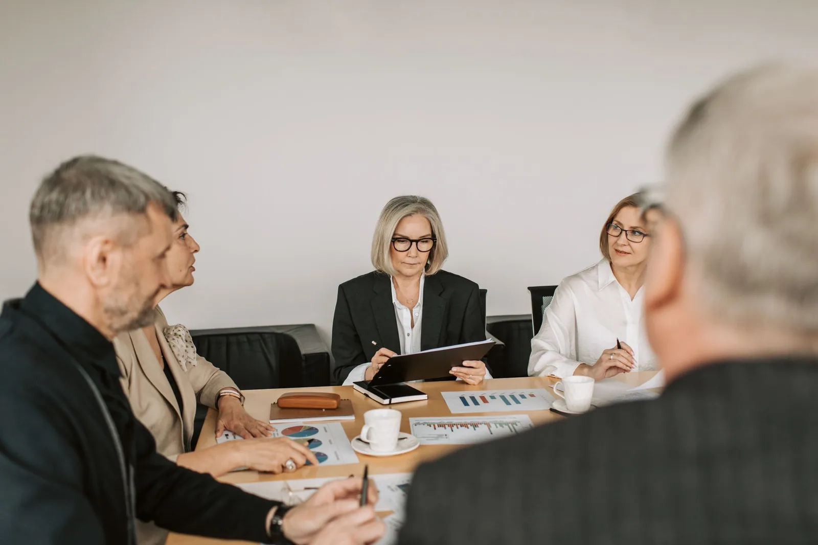 Business advisers discussing documents at an office table