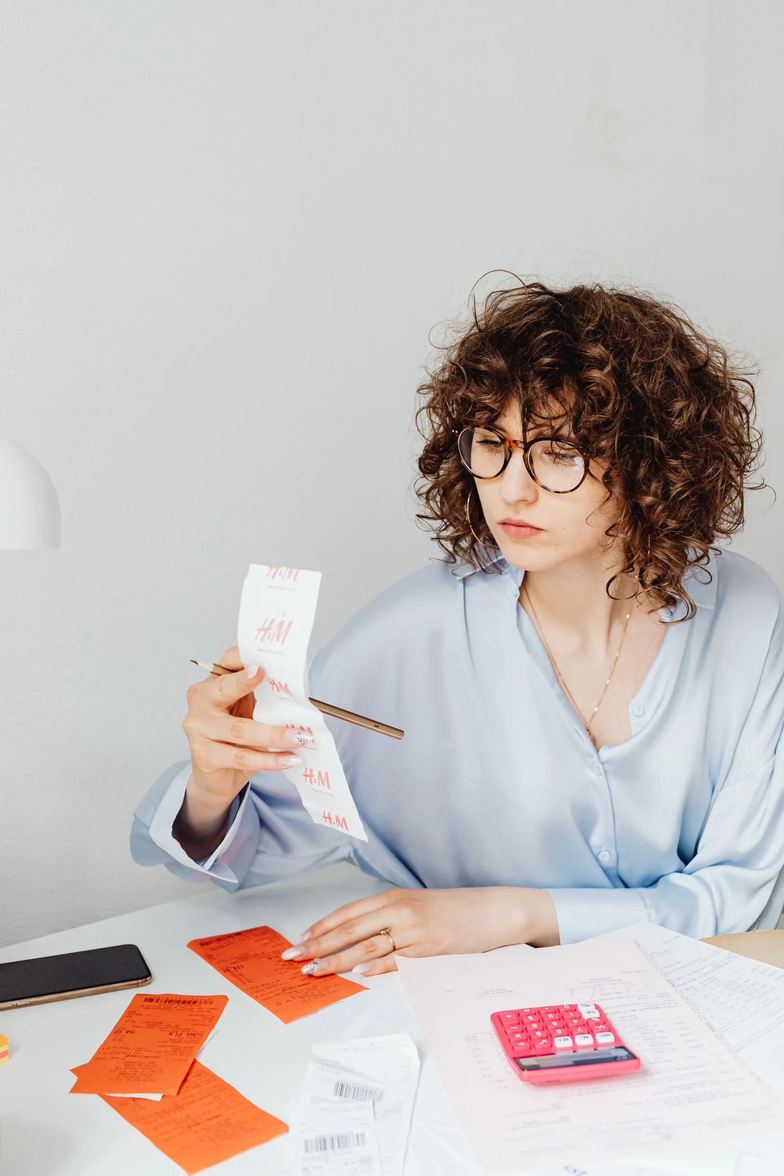A shopper checking receipts and calculations