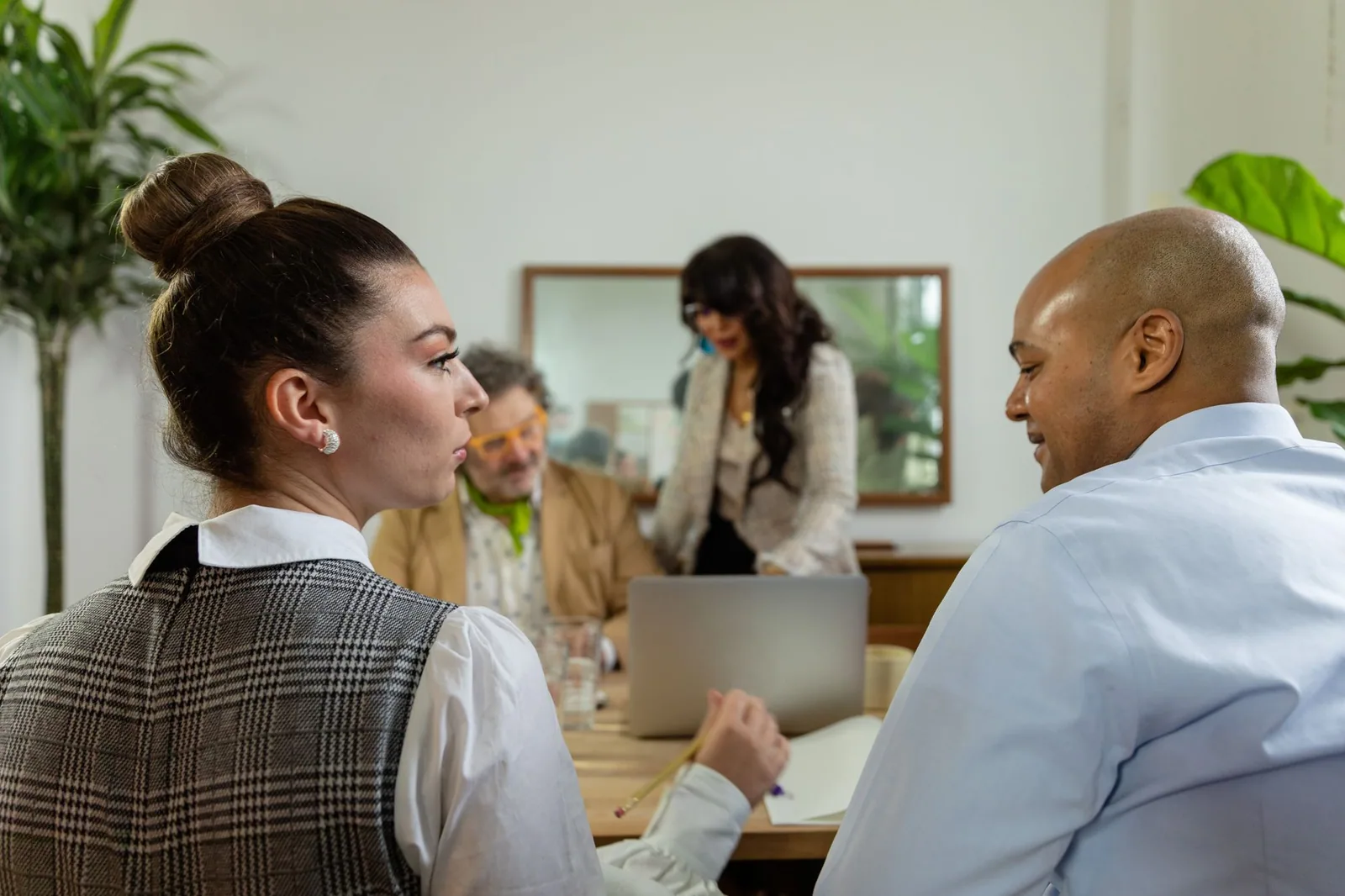 Colleagues collaborating around a laptop
