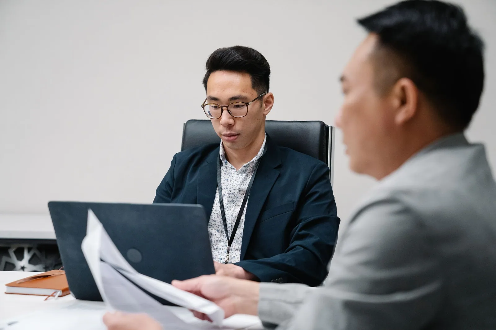 Professionals working with laptops and supporting records