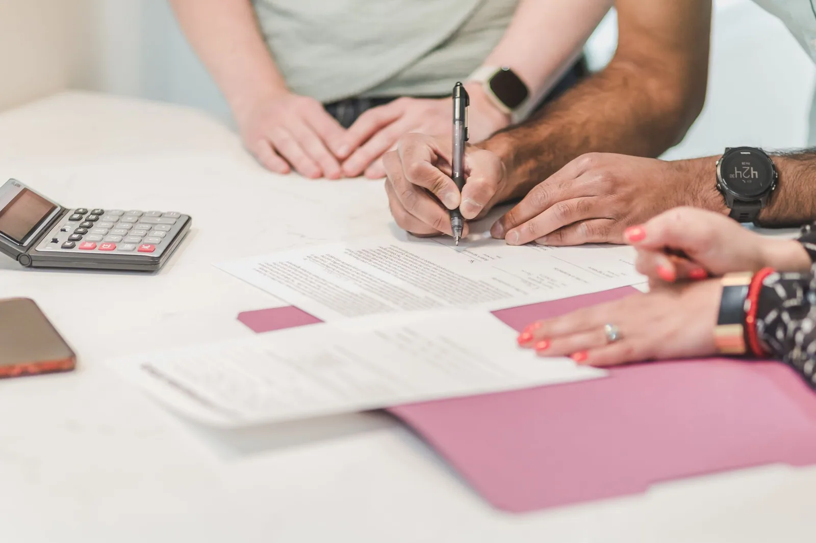 Hands checking and annotating business paperwork