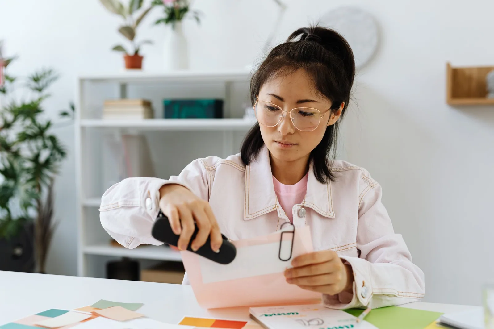 A professional sorting paperwork at a desk